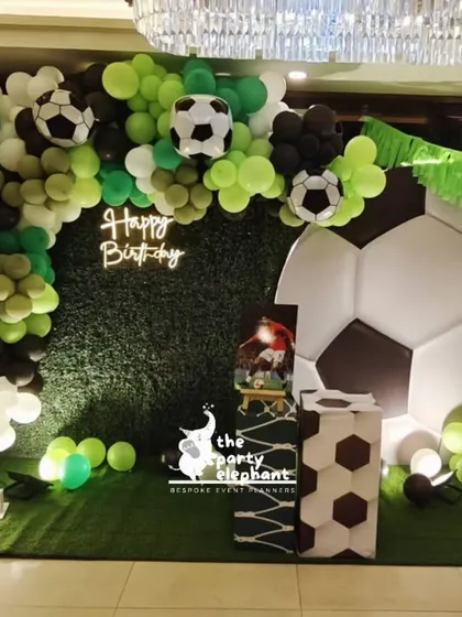 For the ultimate football fan, we created this dynamic backdrop for an 11th birthday. The setup includes a giant 3D soccer ball, a turf-like floor, a neon "Happy Birthday" sign, and marquee numbers, making it the perfect spot for photos.