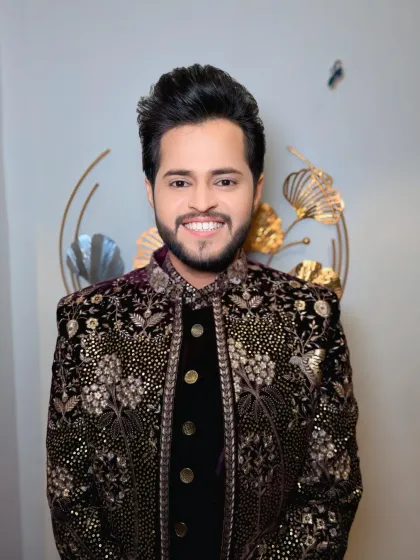 A classic portrait of the groom in his reception attire. The makeup is flawless, and his hair is styled to perfection.