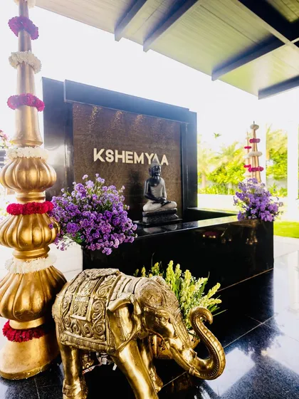The entrance to the Kshemyaa venue, enhanced with our decor. I added large golden props and a brass elephant statue to create a grand and auspicious welcome for the naming ceremony guests.