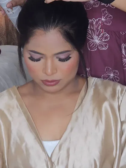 A close-up of the eye makeup for a Christian wedding look, featuring soft pink and shimmer.
