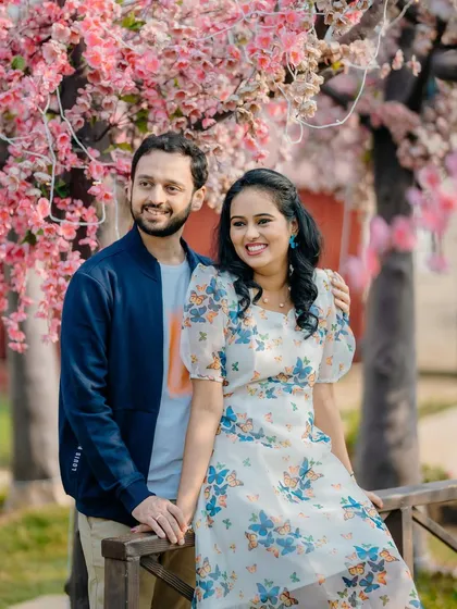 A sweet and casual portrait of Sayali and Siddhesh. The soft pink blossoms in the background add a touch of romance to their pre-wedding photo.