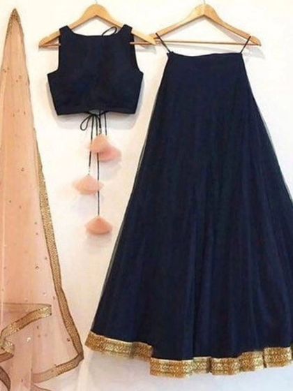 A simple and elegant navy blue lehenga set. The plain skirt and blouse are paired with a contrasting light pink net dupatta, making it a great choice for a wedding guest.