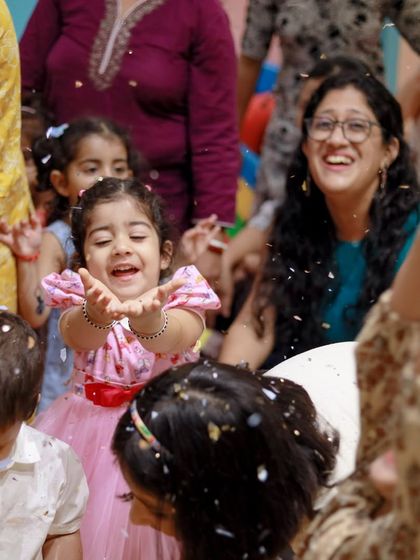 The birthday girl catches confetti with a huge smile. These action shots perfectly capture the spirit of our celebrations.