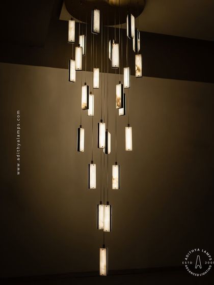 These modern pendants feature a unique combination of translucent marble and stitched leather accents. The warm light glows through the marble, creating a sophisticated and texturally rich fixture for contemporary spaces.