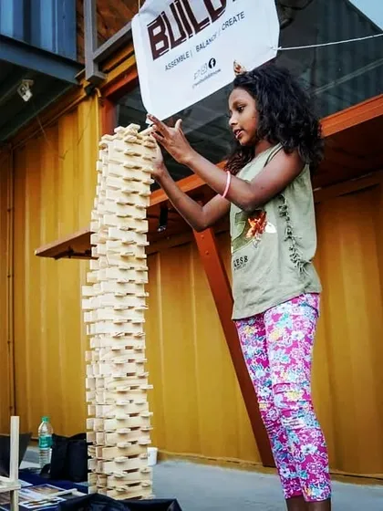 Look at that proud smile! This is the moment it all clicks. After focusing and carefully balancing each plank, this young builder created a tower taller than she is. We see this boost in confidence and sense of achievement in every session, and it's the reason we love what we do.