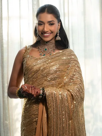 Radiance, redefined with a soft glam for this beautiful wedding guest in a golden Manish Malhotra saree.