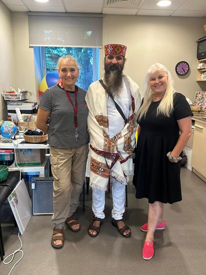 Posing with students in their workspace. It shows how the principles of yoga and mindfulness can be brought into any environment, including our professional lives.