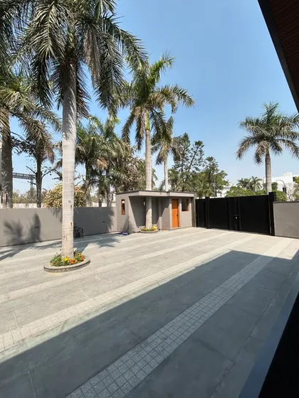 The driveway of Gulmohar Farmhouse, where I designed the paving around existing palm trees. This is a key part of my philosophy: to preserve and celebrate the natural context of a site.