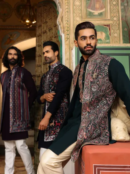 We believe in dressing not just the groom, but the entire wedding party. Here, we showcase three complementary festive looks, featuring intricately embroidered Nehru jackets over solid-colored kurtas, perfect for the groom's brothers or close friends.