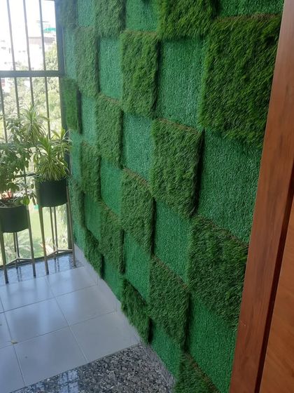 Another angle of the checkerboard grass wall, showing how it complements the natural plants on the balcony railing.