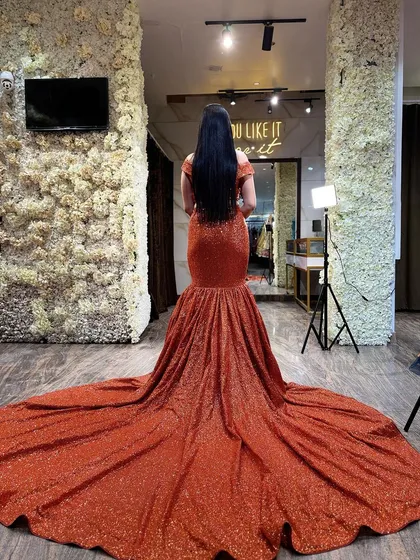 The back view of our orange sequined mermaid lehenga, showcasing its incredibly long and dramatic trail. This is how you make a grand exit.
