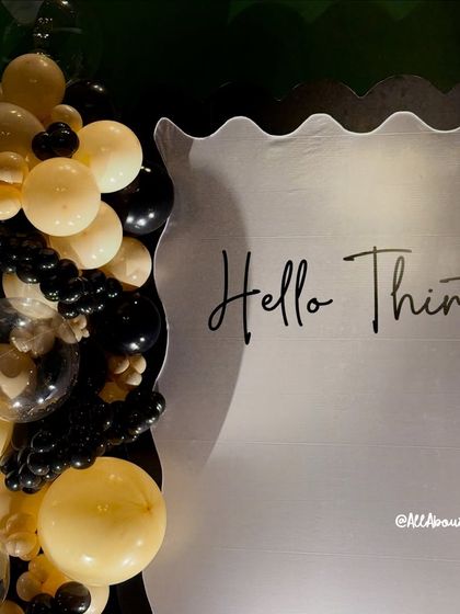 A close-up of the 'Hello Thirty!' backdrop, showing the elegant script and the stylish color combination.