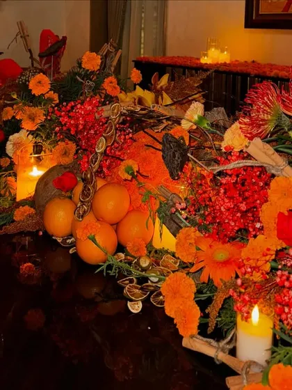 This whimsical and fiery orange tablescape feels like a garden party. I combined oranges, berries, and protea with flickering candles to create a look that is both dainty and disco.