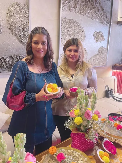 Here, we are exploring how to use natural elements like coconut shells to hold flowers. It's these small, creative details that make a tablescape unique.