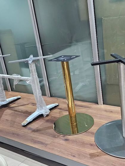 We import and stock a wide variety of table bases and stands. This allows our restaurant and cafe clients to mix and match, choosing from different materials like stainless steel, cast iron, and gold-plated finishes.
