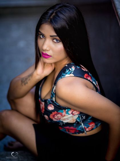 A powerful crouching pose with a direct, challenging gaze. This shot is edgy, confident, and full of attitude.