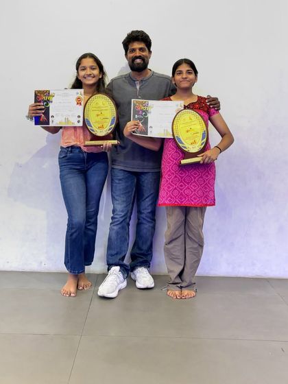 Standing proud with two of our award-winning students. Their trophies and certificates are a testament to their hard work and the high-quality training they receive.