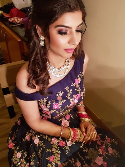 A candid shot capturing the shimmer on her eyelids and the perfect pink lip color.