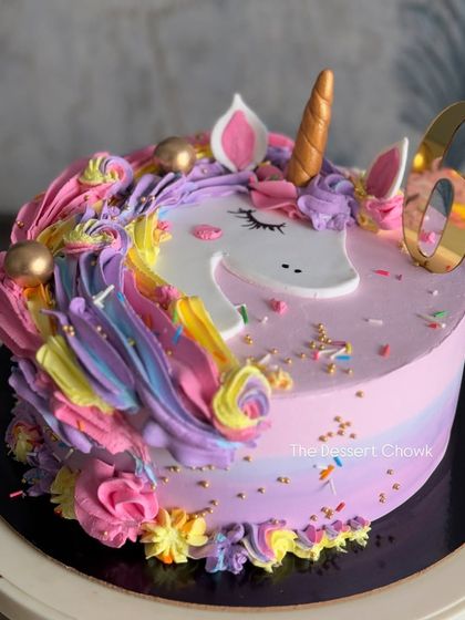 A magical unicorn cake that's always a hit with the little ones. This design features a rainbow of buttercream swirls, a golden horn, and a sprinkle of edible glitter.