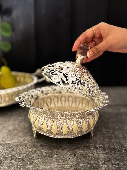 Lifting the filigree lid reveals the treats inside. This piece is designed for those who appreciate the ritual of serving and the beauty of fine craftsmanship.