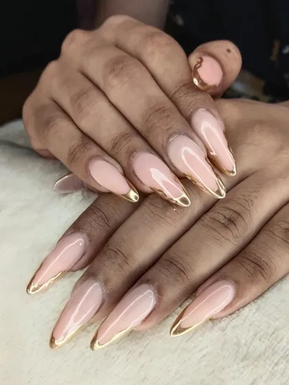 Sometimes, elegance is all you need. These long, stiletto-shaped extensions feature a clean nude base with a delicate gold chrome tip. It's a timeless and sophisticated look that we perfect for our clients.