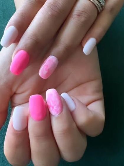 A mix-and-match set featuring solid matte pink, solid white, and a marbled pink and white accent nail.