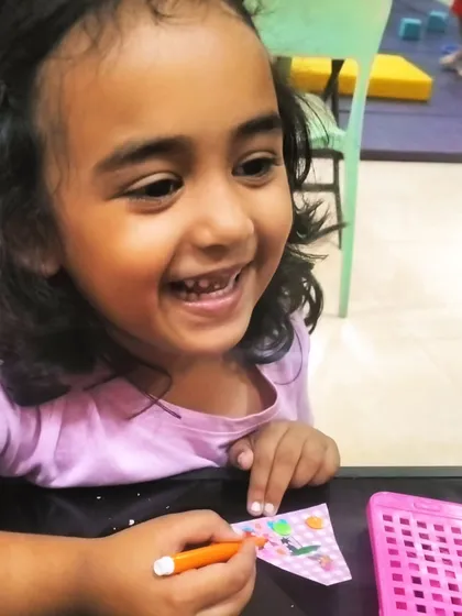 The pure joy of creating something with your own hands. This happy smile says everything about how much fun our Easter craft session was.