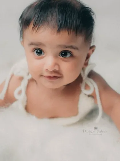 That curious gaze is so captivating. I love capturing these quiet, thoughtful moments during a milestone session.