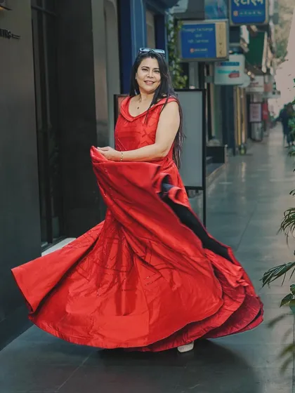 Another shot from the red dress series, this one capturing the fabric's movement from a different angle. Providing variety is key for influencer content, giving them multiple options for their posts.