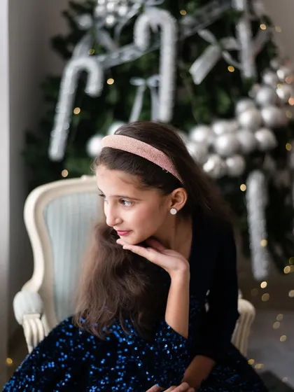 This young girl looked like she stepped right out of a dream. The soft lighting and her thoughtful pose create a beautiful, almost magical portrait that is perfect for the holiday season.