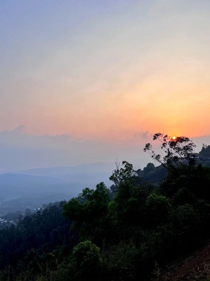 A beautiful sunset view from Raja's Seat in Coorg. The sky is a canvas that changes every minute.