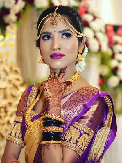 We focus on capturing the elegance of our brides. This is a classic South Indian bridal portrait, highlighting the intricate details of the Kanjeevaram saree, temple jewellery, and flawless makeup.