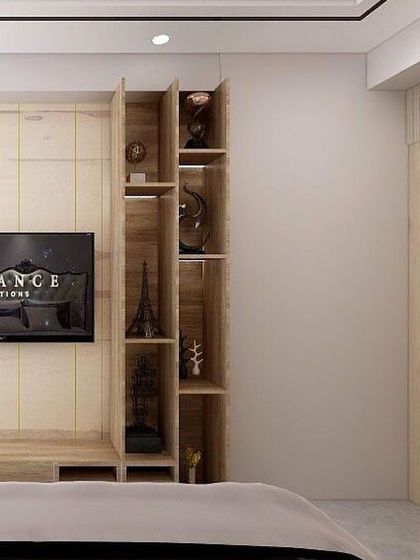 A TV unit designed for a master bedroom in Noida. The wall paneling cleverly conceals the washroom door, and an integrated shelving unit provides space for displaying collectibles.