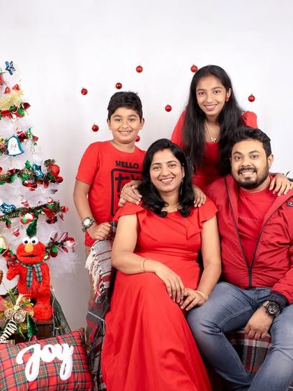 The whole family gets in on the festive fun. This Christmas-themed studio portrait captures the joy and togetherness of the holiday season.