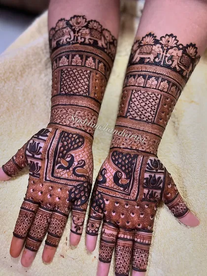 A closer look at the details. You can see the clean lines in the elephant motifs and the delicate shading in the peacock figures, all done with a steady hand.