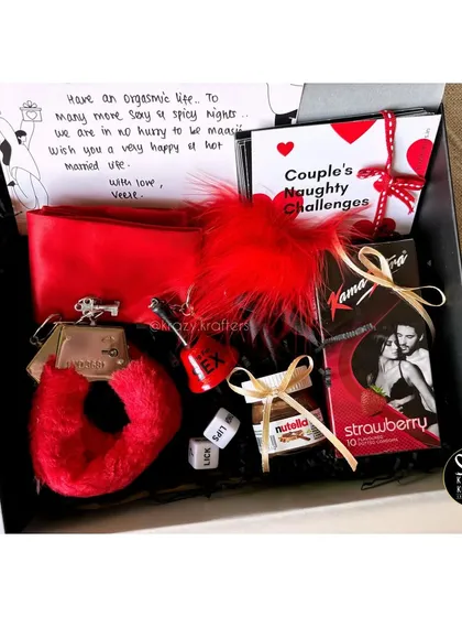 This 'Kinky Hamper' is a fun and naughty experience in a box. It includes fuzzy handcuffs, couple's challenge cards, and other playful items for a memorable night.