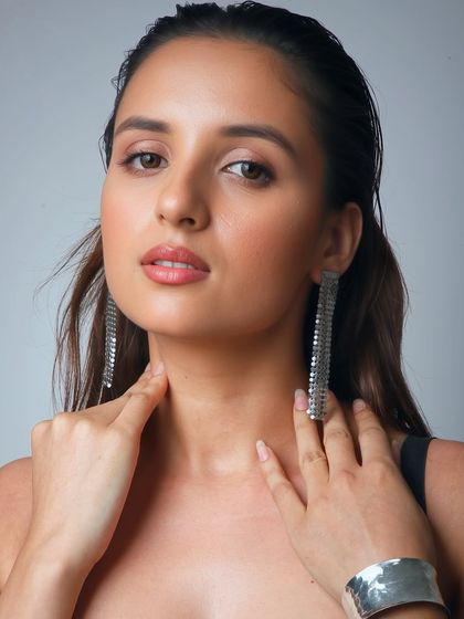 A close-up on the skin and lips. The focus is on a healthy, radiant glow that looks effortlessly chic.