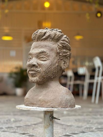 A full-frontal view of the sculpted bust, showcasing the artist's skill in capturing a realistic and expressive portrait.