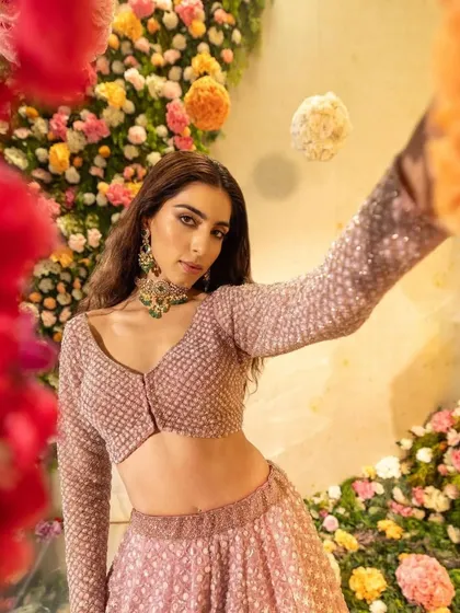 A playful shot that highlights the movement and sparkle of the lehengas.
