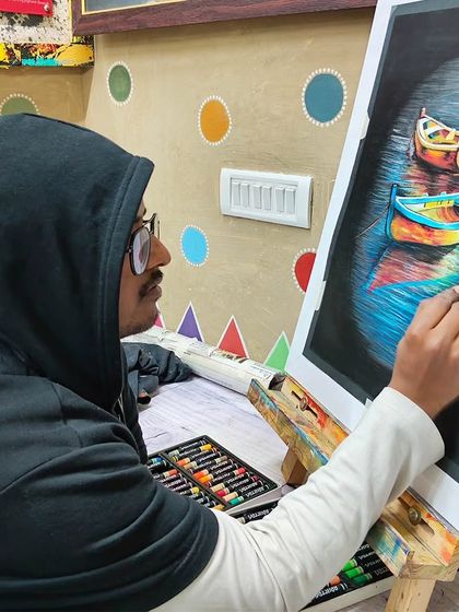 Here is the artist at work on his oil pastel boat scene, carefully blending colors to achieve the water's reflective quality.