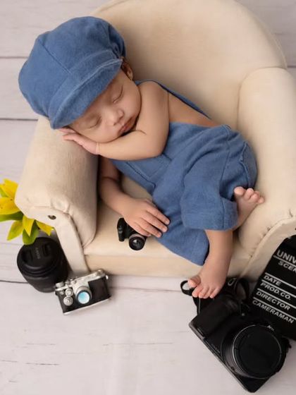 A sweet, sleeping profile of our future photographer, nestled on his miniature couch.