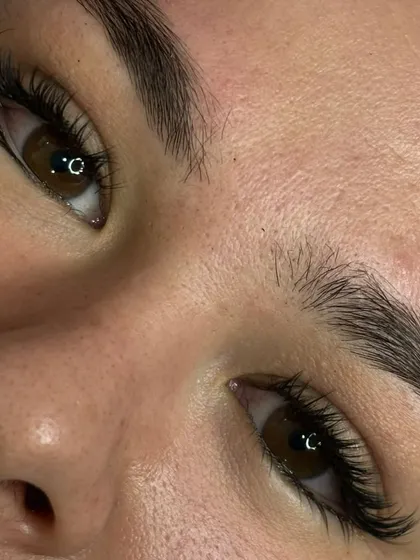 A stunning close up of a completed lash extension set. You can see the clean application and the beautiful curl that lifts the entire eye area. This is the result of our detailed and patient approach to lash artistry.