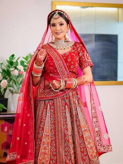 A full-length portrait of the bride in her red lehenga, shot with a Canon R10 and 35mm lens. This shows my versatility with different camera bodies and lenses.
