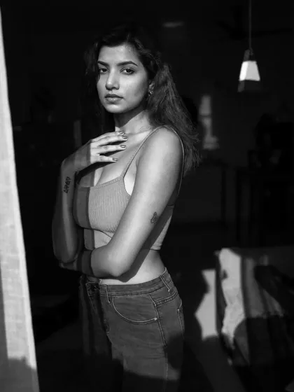 An indoor series using shadows from a window to create patterns on the subject. This shows a creative approach to using natural light in a domestic setting.