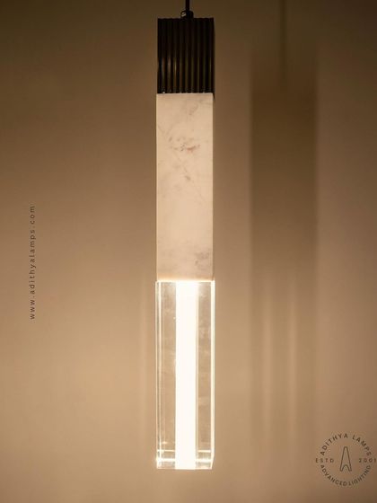 A collection of our pillar pendants, which combine sections of solid marble, fluted metal, and clear crystal. These substantial, high-quality fixtures can be hung individually or in clusters to create a dramatic effect in stairwells or entryways.