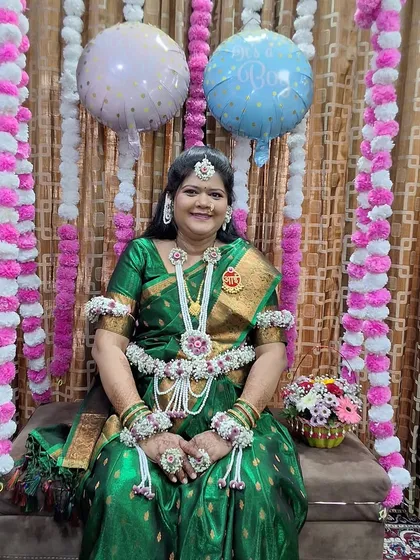 A happy client wearing a full set of my white and green floral jewellery for her baby shower celebration.