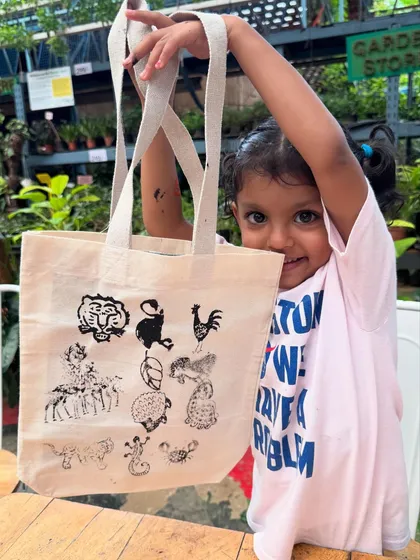 Look at that proud smile! I love seeing little artists bring their imagination to life. In this block printing session, we used safe, non-toxic inks to create wearable art that also teaches about our beautiful animal kingdom.