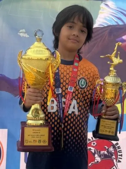Our 7 year old midfield genius, Arash, with his well earned trophies. His game sense and leadership are remarkable for his age.