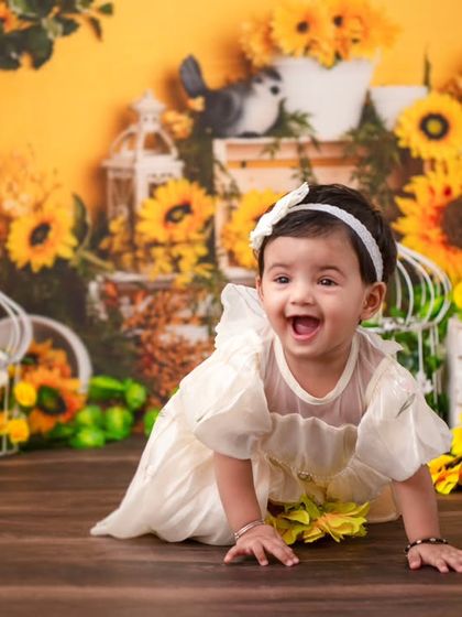 A crawling shot amidst a field of sunflowers. This dynamic photo captures the joy and energy of a one-year-old on the move.