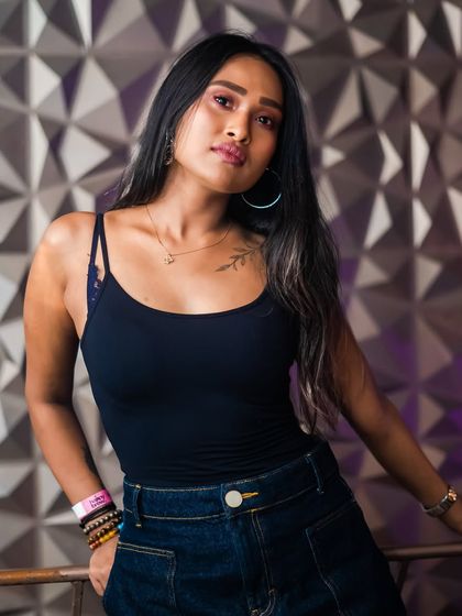 A guest posing against the textured wall, a popular photo spot.